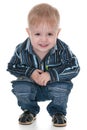 Smiling toddler sits down Royalty Free Stock Photo