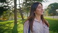 Smiling tourist enjoying sunny park embodying casual joy closeup. Girl walking