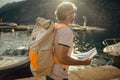 Tourist mature man standing with map and backpack near the sea Royalty Free Stock Photo