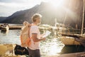 Tourist mature man standing with map and backpack near the sea Royalty Free Stock Photo