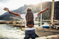 Tourist mature man standing with map and backpack near the sea Royalty Free Stock Photo