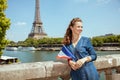 Smiling tourist woman with France flag exploring attractions Royalty Free Stock Photo