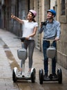 Smiling tourists going sightseeing by segways