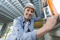 smiling tradesman using spirit level Royalty Free Stock Photo