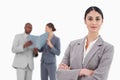 Smiling tradeswoman with arms crossed and team behind her Royalty Free Stock Photo