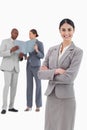 Smiling tradeswoman with crossed arms and team behind her Royalty Free Stock Photo