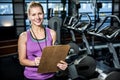 Smiling trainer holding clipboard