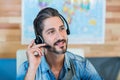 Smiling travel agent having phone call Royalty Free Stock Photo