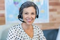 Smiling travel agent sitting at her desk Royalty Free Stock Photo