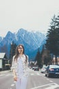 Smiling travel girl standing on the road.