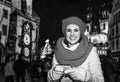 Smiling traveller woman at Christmas in Prague writing sms Royalty Free Stock Photo