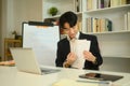 Smiling tutor explaining a worksheet to student during an online learning session