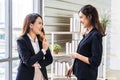 Smiling two business woman talking with partner while standing in modern office interior, team of professional employees Royalty Free Stock Photo