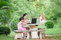 Smiling two sisters using laptop outdoor Royalty Free Stock Photo