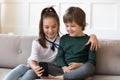 Happy little kids use smartphone at home Royalty Free Stock Photo