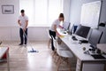 Smiling Two Young Janitor Cleaning The Office Royalty Free Stock Photo