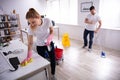 Smiling Two Young Janitor Cleaning The Office Royalty Free Stock Photo