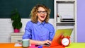 Smiling university student girl preparing for test or exam using laptop. High school. Female teacher in glasses working Royalty Free Stock Photo