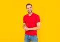 smiling unshaven young man in red shirt on yellow background, fashion