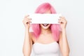 Smiling Very Attractive Woman With Sunglasses , Pink Hair, Holding A White Blank Sign, White Backgro