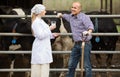 Smiling veterinarian chatting with farmer Royalty Free Stock Photo