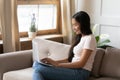 Smiling Vietnamese girl typing on modern laptop at home Royalty Free Stock Photo