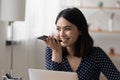 Smiling Asian girl activate virtual voice assistant on cellphone Royalty Free Stock Photo