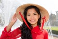 Smiling Vietnamese woman in a red Ao Dai