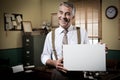 Smiling vintage businessman holding a blank sign Royalty Free Stock Photo