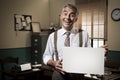 Smiling vintage businessman holding a blank sign Royalty Free Stock Photo