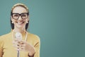 Smiling vintage style woman standing in front of a microphone