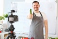 Smiling Vlogger Chef Recording Green Cucumber