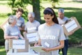 Smiling volunteer brunette writing on cipboard Royalty Free Stock Photo