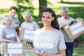 Smiling volunteer brunette writing on cipboard Royalty Free Stock Photo