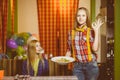 Smiling waiter brought order and dessert to cafe