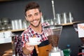 Smiling waiter offering cup of coffee Royalty Free Stock Photo