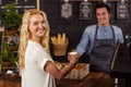 Smiling waiter serving a coffee to a customer Royalty Free Stock Photo