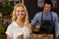 Smiling waiter serving a coffee to a customer Royalty Free Stock Photo