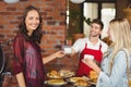 Smiling waiter serving a coffee to a customer Royalty Free Stock Photo