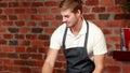 Smiling waiter tiding up the counter