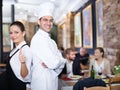 Smiling waitress with chef in the restaurant Royalty Free Stock Photo