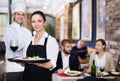 Smiling waitress with chef in the restaurant Royalty Free Stock Photo