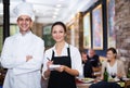 Smiling waitress with chef in the restaurant Royalty Free Stock Photo