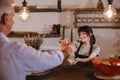 Smiling waitress at counter giving eco friendly paper bag Royalty Free Stock Photo