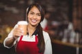 Smiling waitress handing a take-away mug Royalty Free Stock Photo