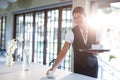 Smiling waitress serving cup of coffee Royalty Free Stock Photo