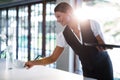 Smiling waitress serving cup of coffee Royalty Free Stock Photo