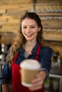 Smiling waitress serving a cup of coffee to in cafÃÂ© Royalty Free Stock Photo