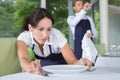 Smiling waitress setting table in restaurant Royalty Free Stock Photo