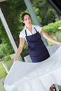 Smiling waitress setting table in restaurant Royalty Free Stock Photo